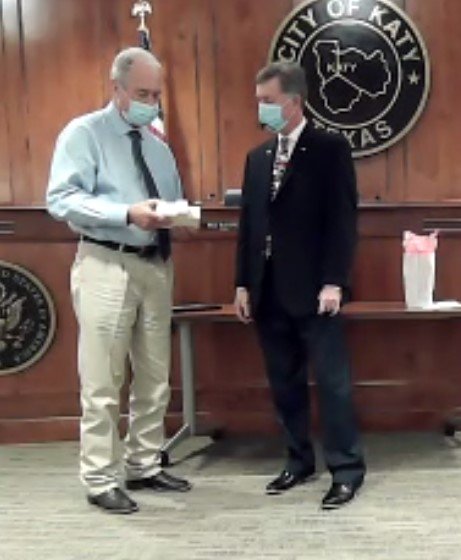Katy Mayor Bill Hastings (left) presents a plaque to former council member Durran Dowdle (right) who has served the city for more than a decade through various boards and as a council member and Mayor Pro Tem. Dowdle served on council during the terms of three mayors, Fabol Hughs, Chuck Brawner and Hastings.